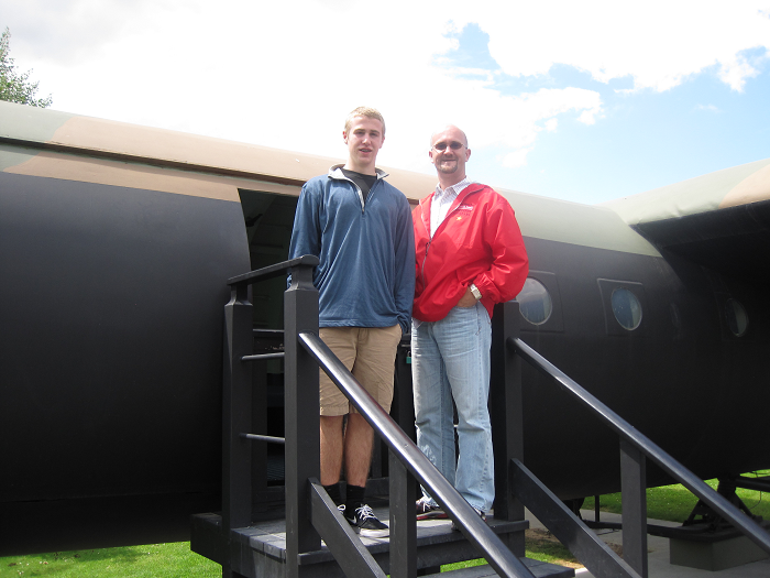 Sam Spare and Kevin Wagner outside the Memorial Pegasus Museum in Normandy with a restored glider like the one William T. McCabe would have flown in World War II