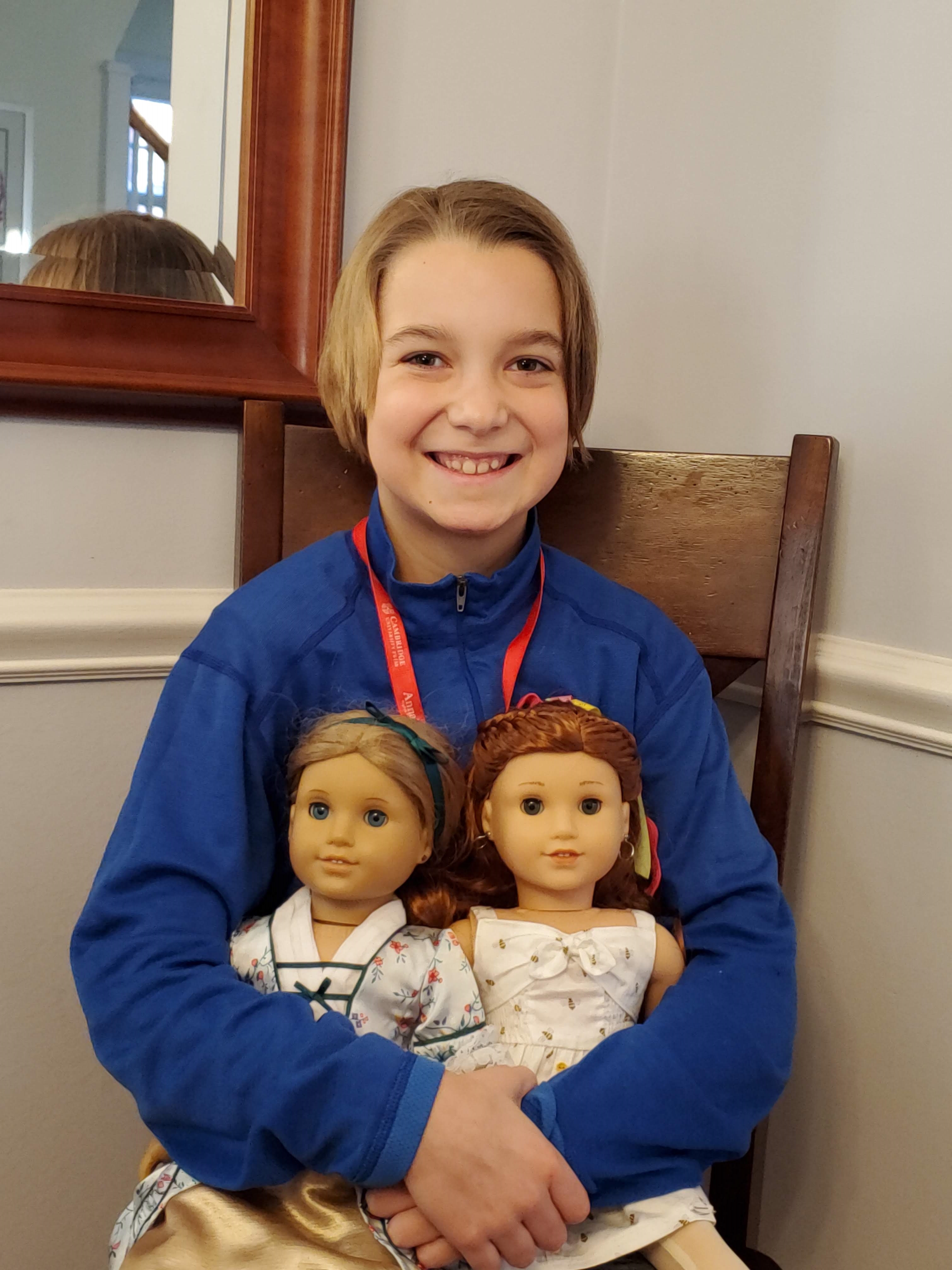 One attendee poses with her American Girl dolls, Elizabeth and Blair.