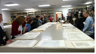 Alan Jutzi, Avery chief curator, rare books, provides participants with a guided tour through some of the rare volumes of maps in the library's collection. Photo by Robert B. Townsend.