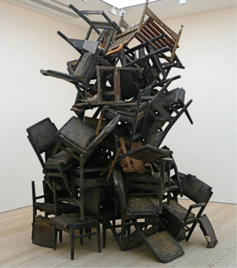 Photo by <a href="http://www.flickr.com/photos/herry">Herry Lawford</a>, CC-BY 2.0.<p> Dance of Democracy by Mansoor Ali, Saatchi Gallery, London, 2008. The once-discarded chairs in this installation are not attached, but are part of a delicate balancing act.