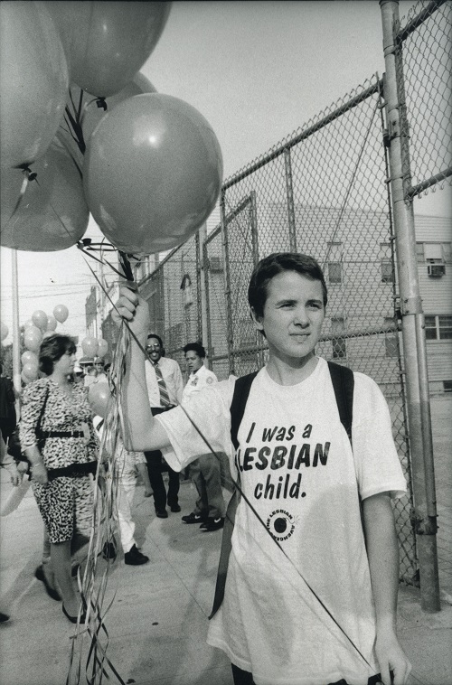 In late 1991, the New York City Board of Education approved the multicultural Children of the Rainbow curriculum, which incorporated lessons and readings for schoolchildren on many identity groups. But a firestorm erupted after a district school board refused to adopt the curriculum, citing two optional books for first graders about families with lesbian and gay parents. In response, an activist group, the Lesbian Avengers, handed out balloons to children in front of an elementary school. The balloons read, "Ask about Lesbian Lives." Actions like these paved the way for educators to incorporate LGBT people into K-12 curricula. Photograph: Donna Binder