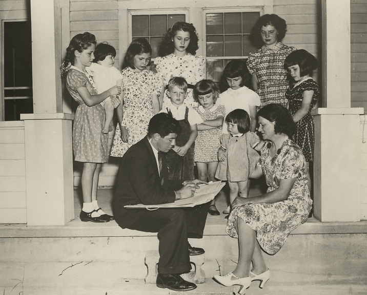 A 1940 census worker counts a family, asking 50 questions in the longest census to date.