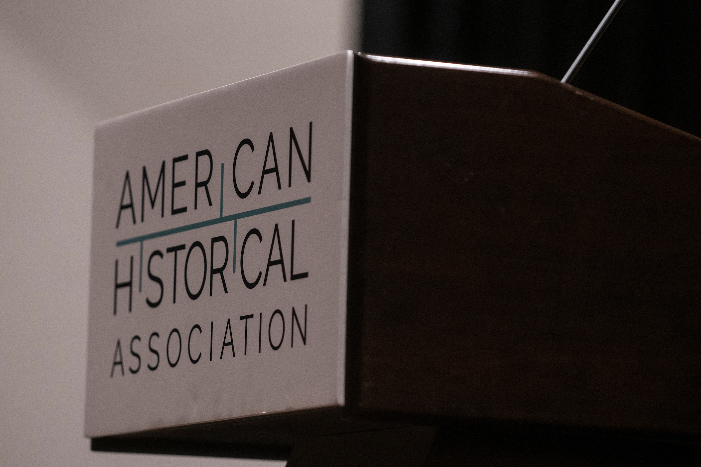 A wooden lectern with the American Historical Association logo on the front.