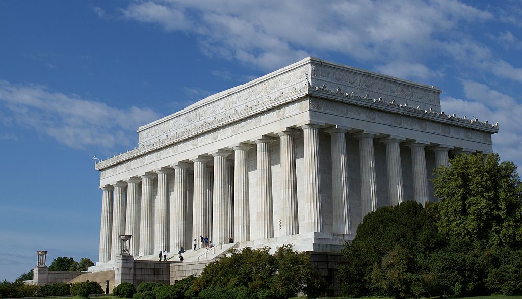 The Lincoln Memorial, a white marble building resembling a temple with 36 columns surrounding the exterior.