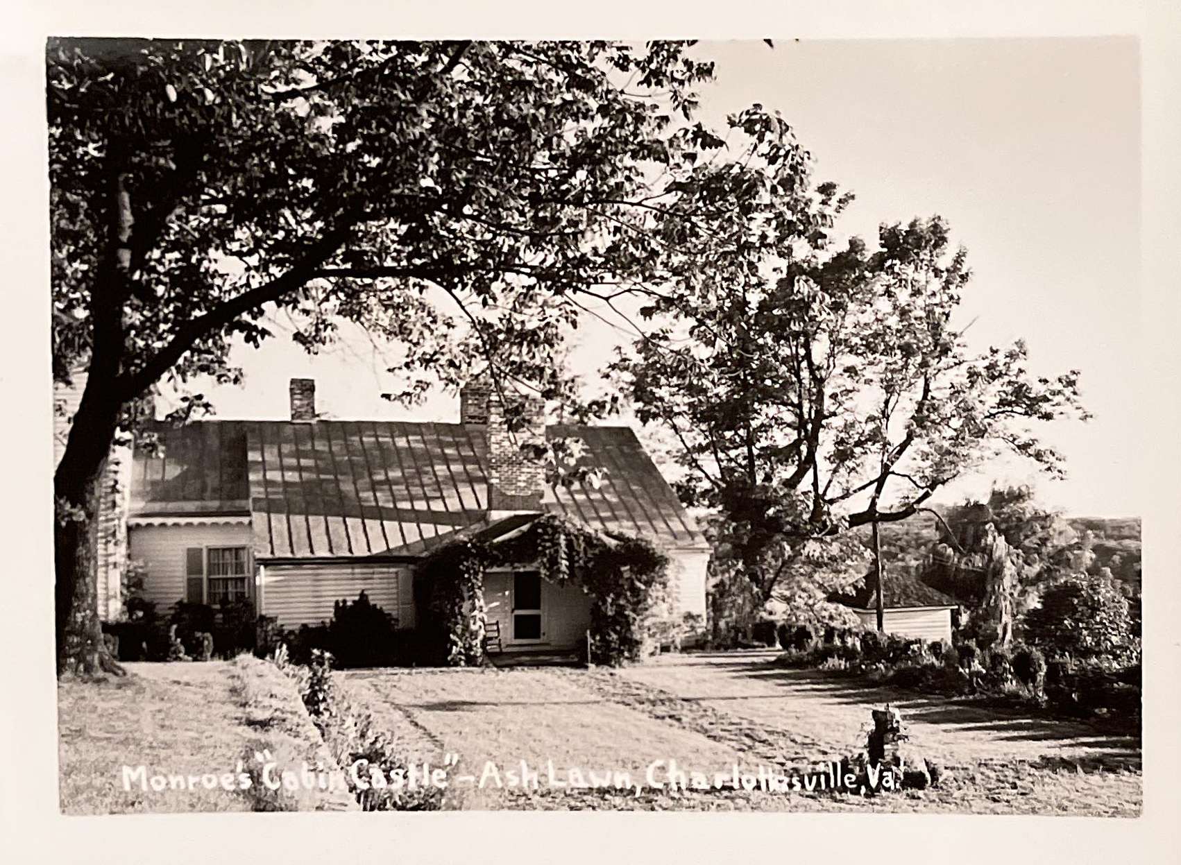 A black and white photo of a small cottage captioned as “Monroe’s ‘Cabin Castle’—Ash Lawn, Charlottesville, Va.