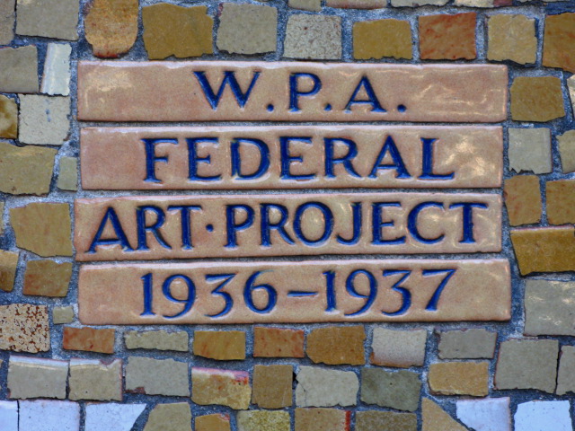 A mosaic of tan tiles with the engraved text “W.P.A. Federal Art Project 1936–1937” in blue lettering
