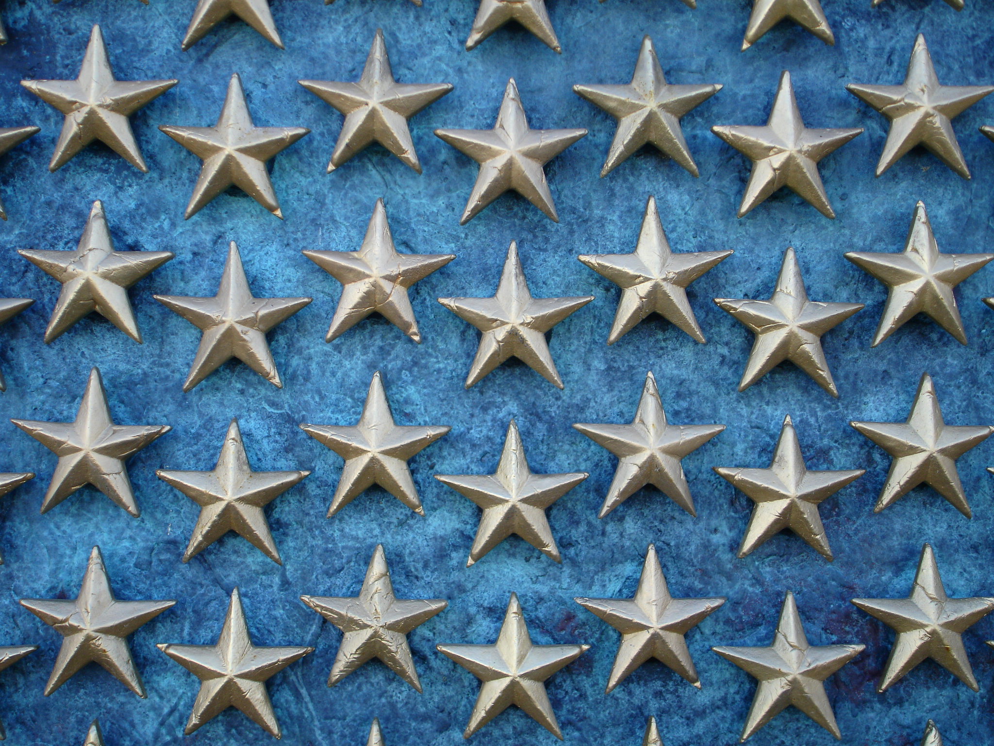 A field of gold five-pointed stars on a blue background.