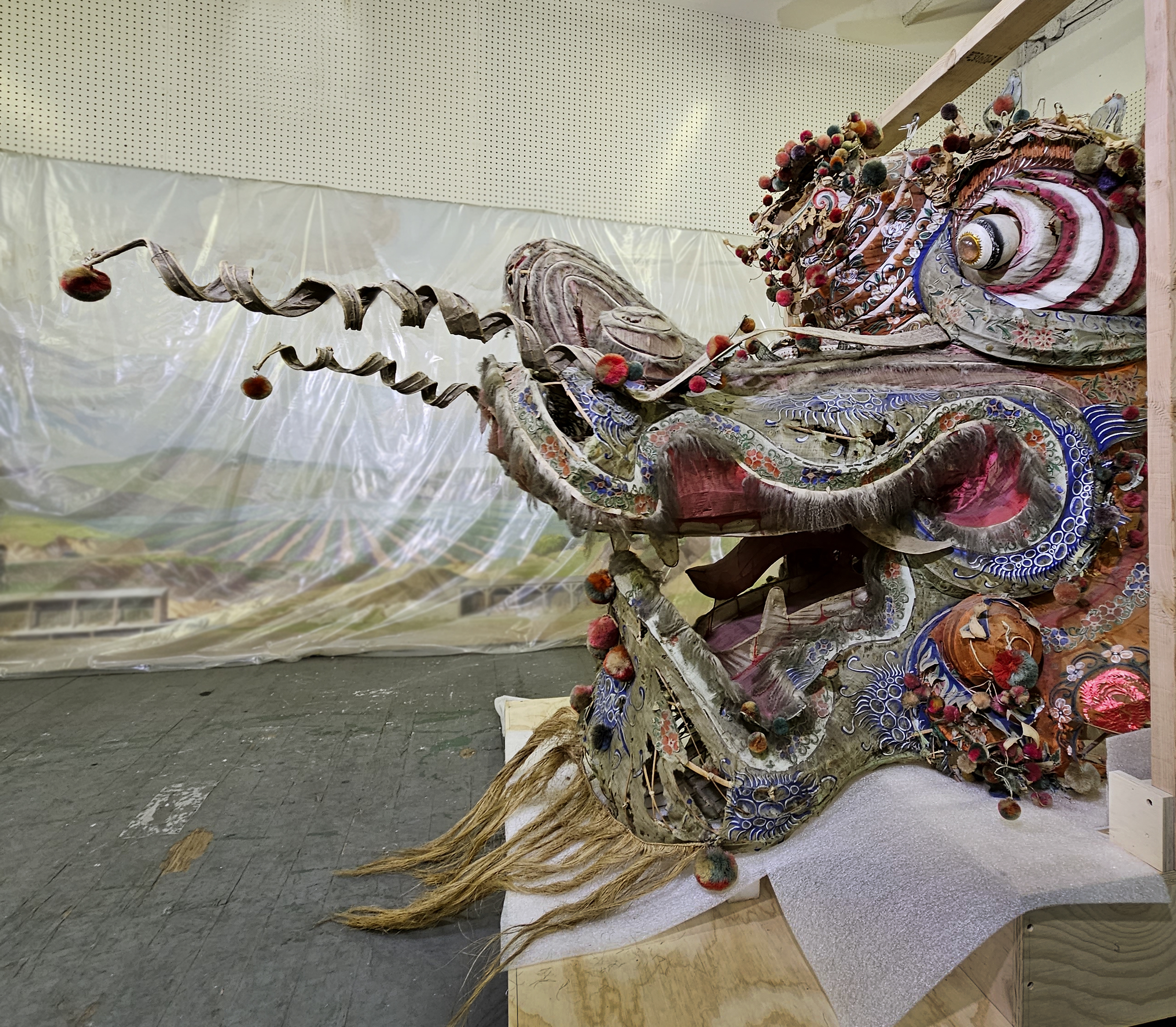 A large dragon head made from various crafting materials in storage