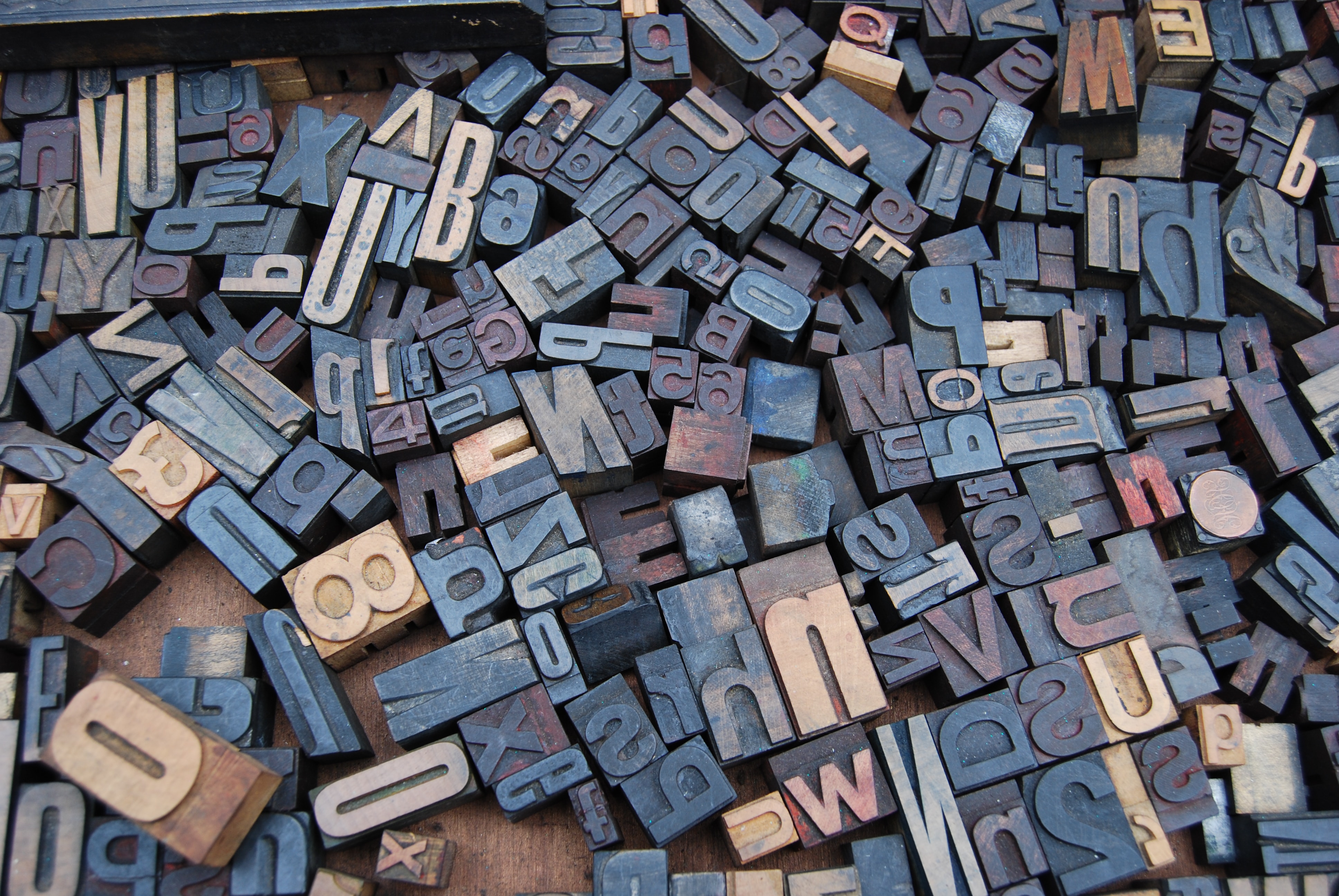 A pile of letter wood stamps