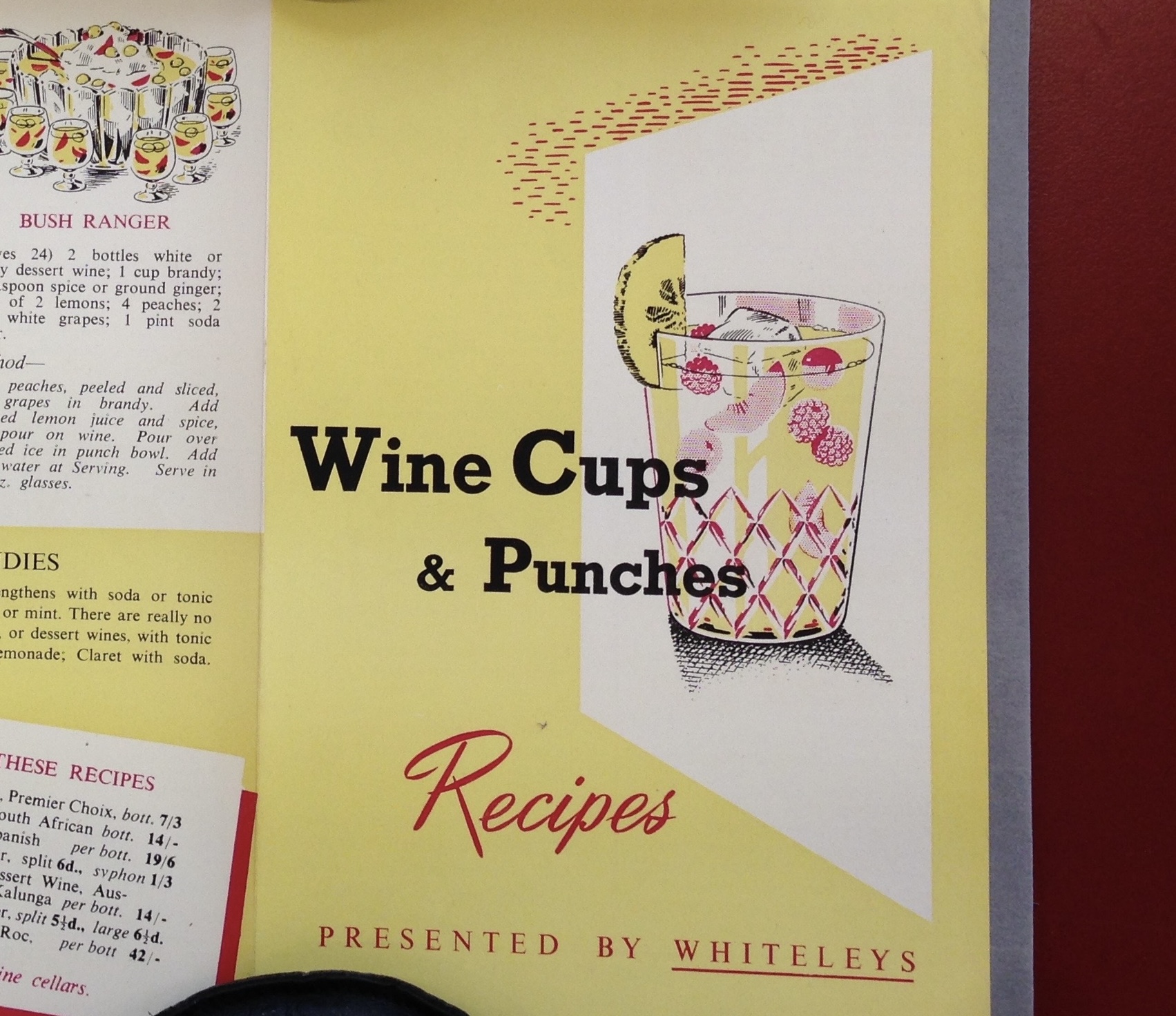 Yellow recipe page with text 'Wine Cups & Punches Recipes Presented by Whiteleys' and an illustration of a glass of punch with fruit in it.
