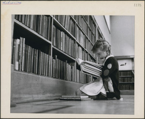 Young girl reading a book, Central Circulating Library at College and St. George Streets, Toronto, Ontario. CC BY 2.0, on Flickr.