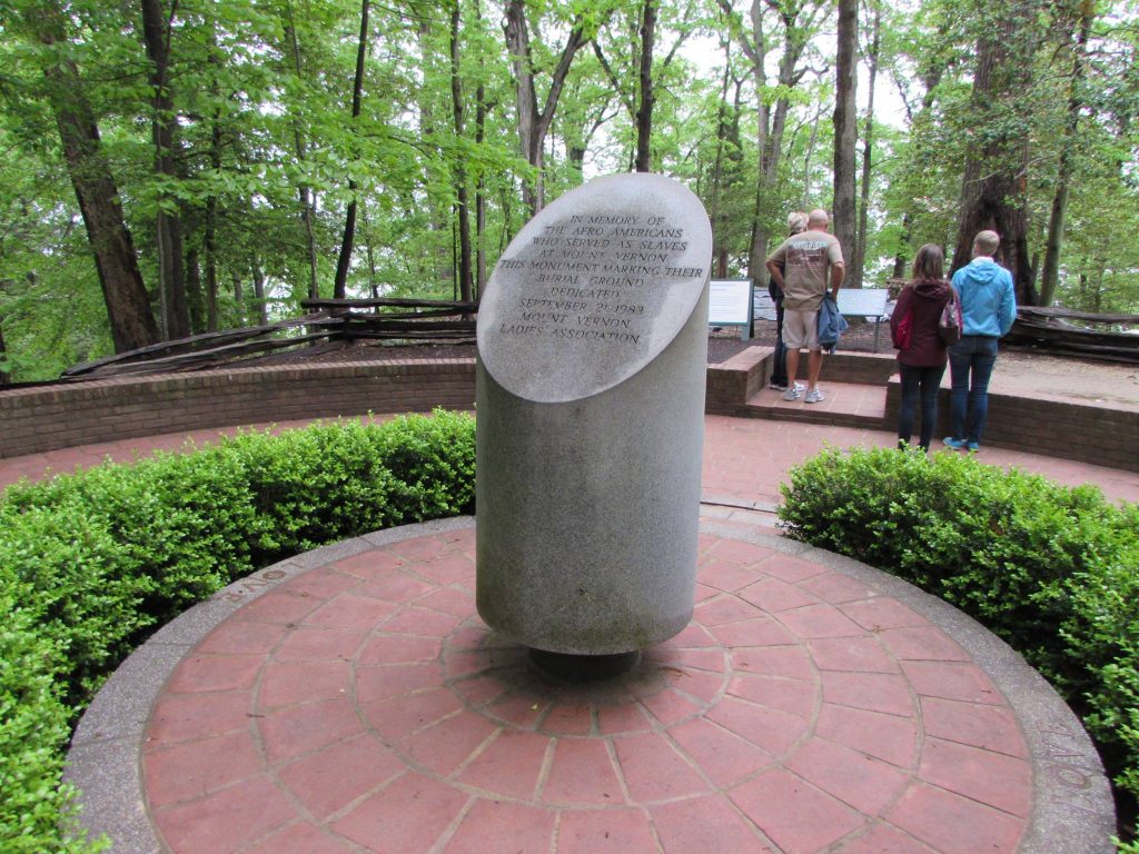 The Slave Memorial at Mount Vernon; the slave cemetery can be seen in the background. In 1983, this monument to the enslaved African Americans who worked at Mount Vernon replaced an earlier one from 1929. The later monument’s placement may have impacted the cemetery it was meant to commemorate. Kritika Agarwal