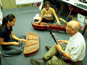 Image of Cambodian young women learning music. The Cambodian Association of Illinois incorporates arts and cultural preservation into its social service programming aside from providing a site for the Cambodian American Heritage Museum and Killing Fields Memorial. Photo courtesy Cambodian Association of Illinois.