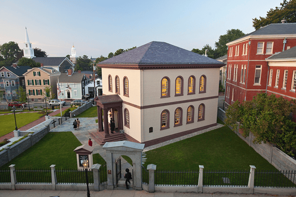 Touro Synagogue, designed by Peter Harrison and dedicated in 1763, exemplified Jewish social inclusion in British colonial seaports. A visit to Touro in Newport, Rhode Island, was the inspiration for George Washington’s 1790 commentary on religious freedom, “the United States gives to bigotry no sanction, to persecution no assistance.” Photo Credit: Michael Milford, 2009. Courtesy of the George Washington Institute for Religious Freedom.