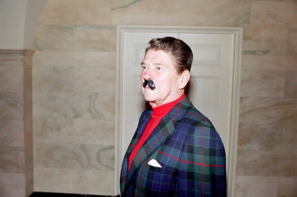 9/23/1987 President Reagan wearing a fake mustache during Congressional Barbecue in the Ground Floor Corridor