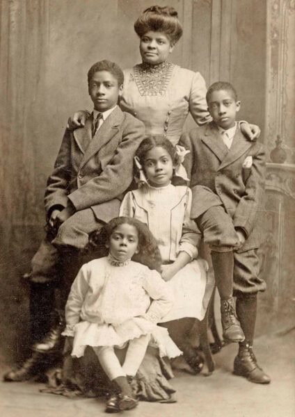 Black and white image of Ida B Wells with her four children