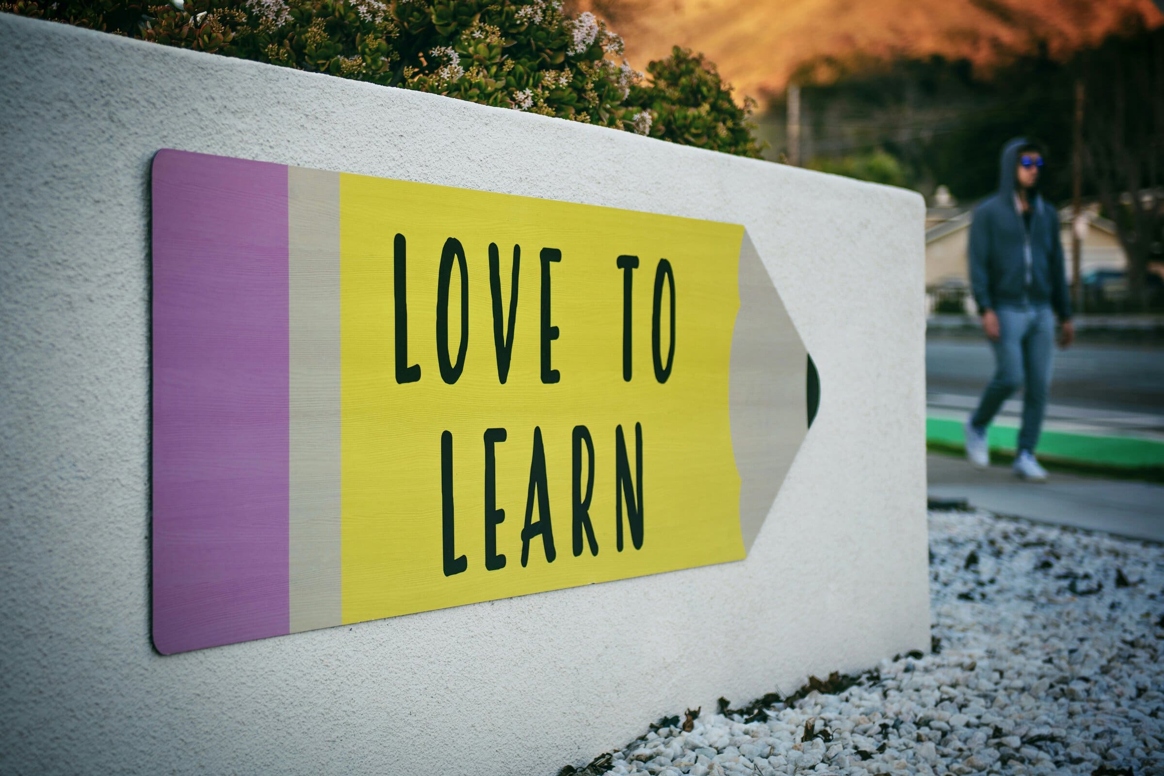 Love to Learn on pencil shaped sign Love to Learn on pencil shaped sign