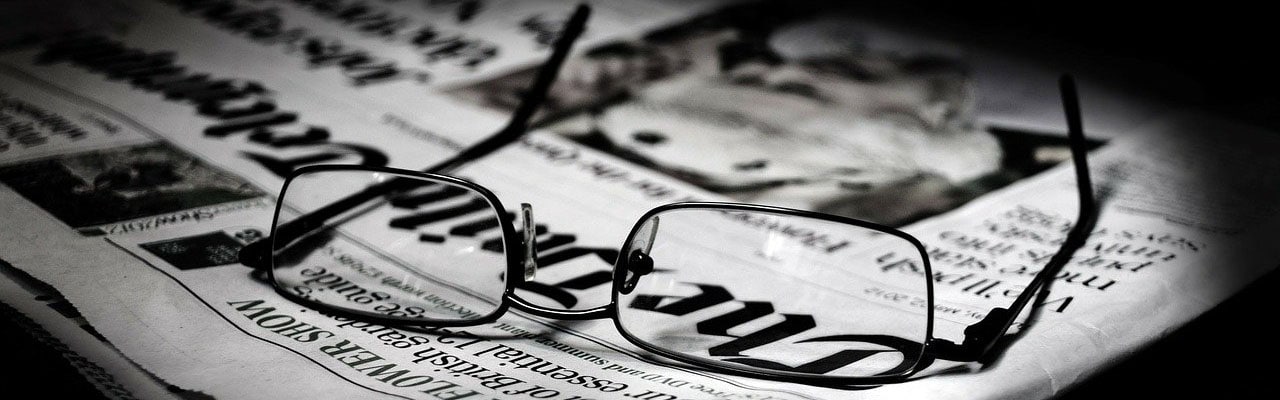 history behind the headlines Glasses laid on newspaper