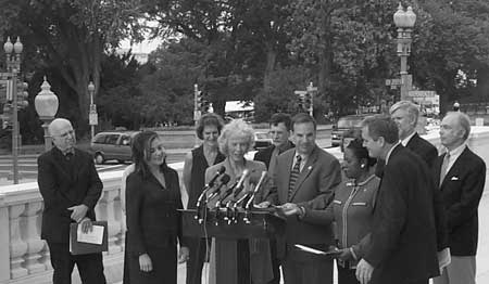 Historian Joyce Appleby presents the historians' petition to Representatives Loretta Sanchez, Bob Filner, Sheila Jackson Lee, and Lloyd Doggett as several historians look on. Photo by Chris Hale.
