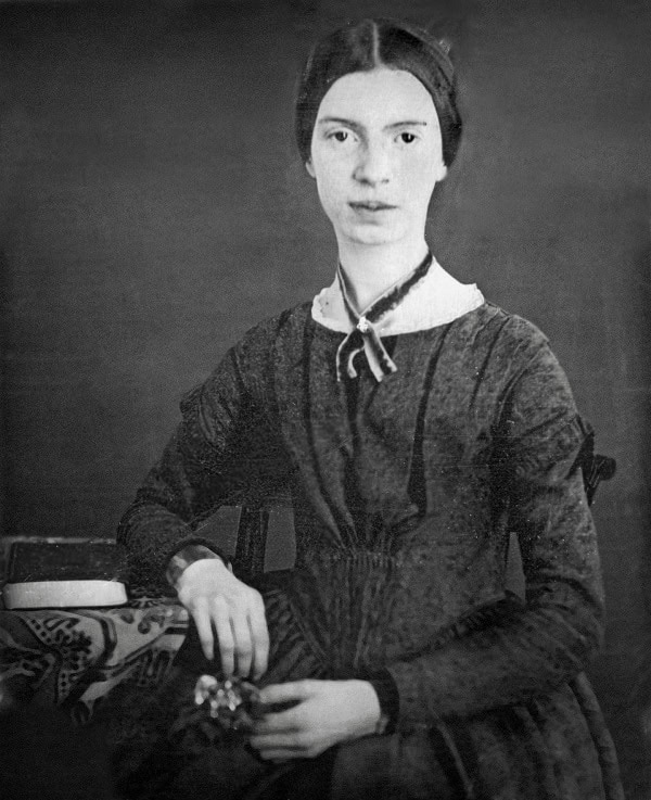 Black and white photo of Emily Dickinson sitting