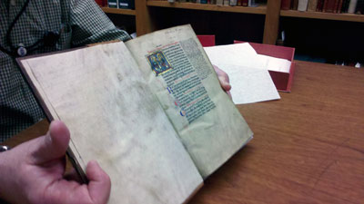 A curator displays one of the many illuminated rare books in the history of medicine collections of the National Library of Medicine. Photo by Elisabeth Grant.