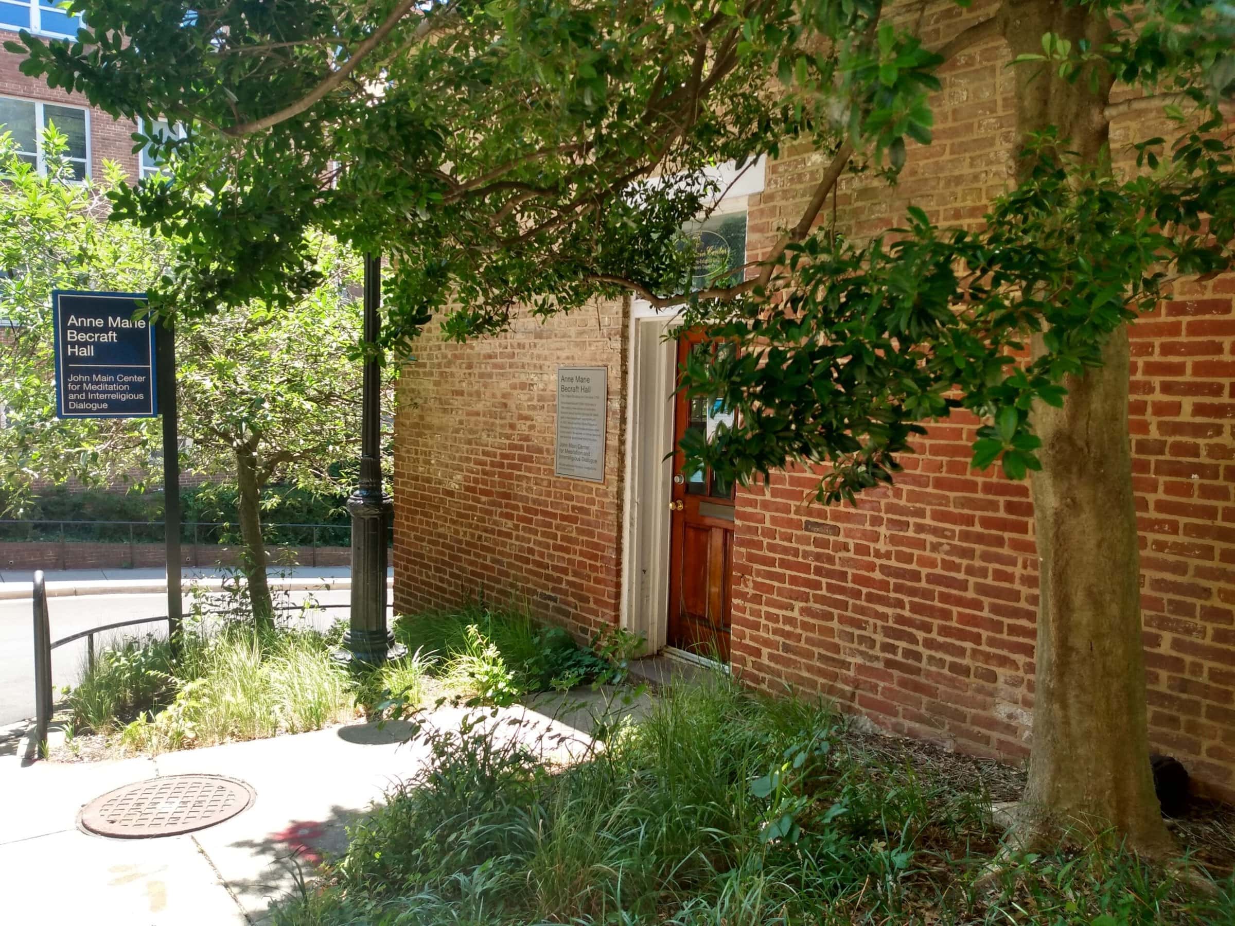 Trees in front of a red brick building.