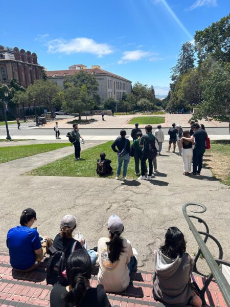 A group of students on a walking tour outside on the UC Berkeley campus