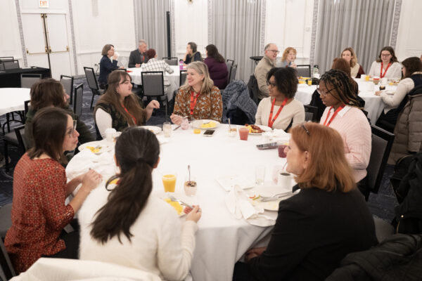 A group of women talking around a round table